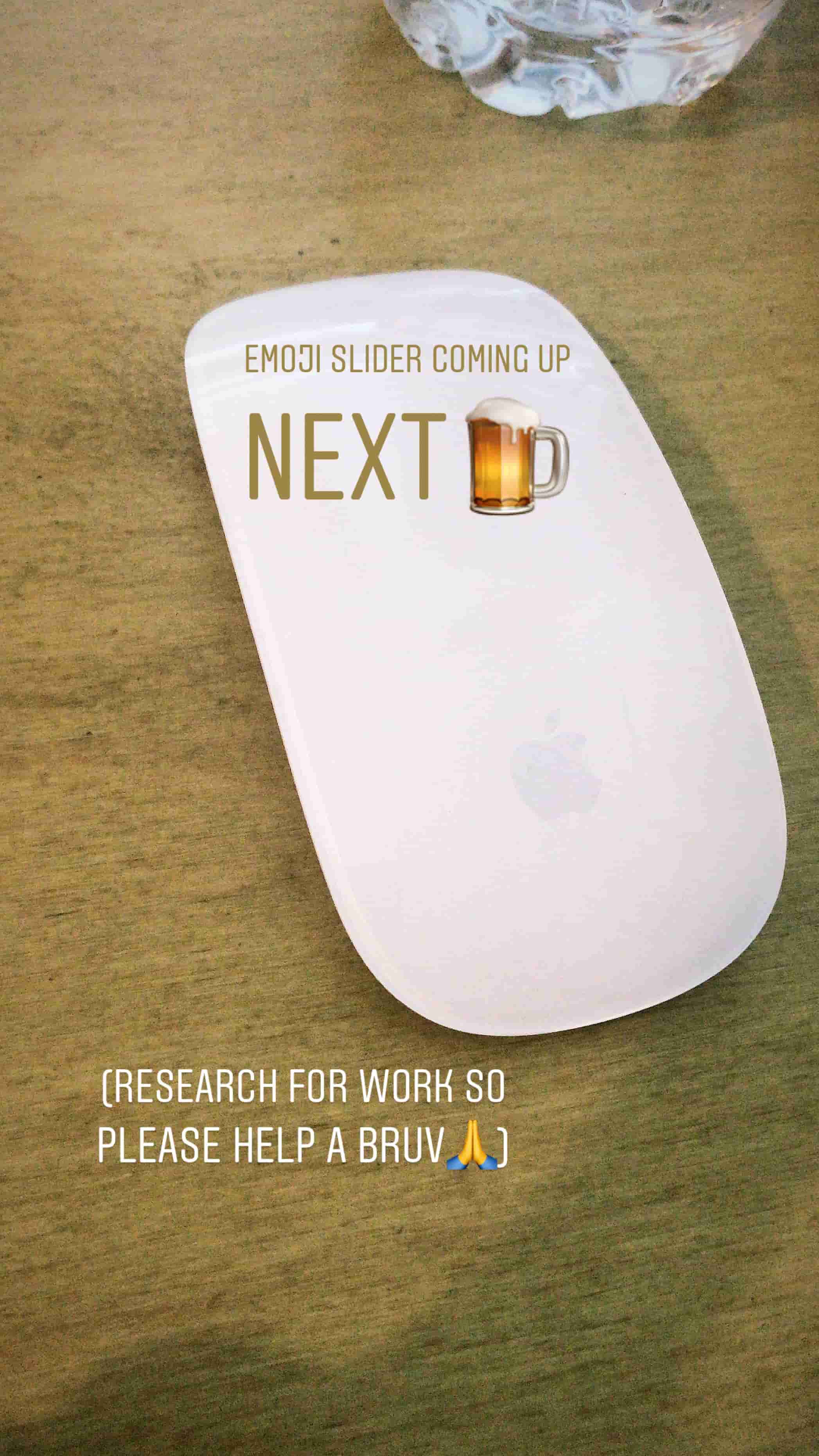 white apple mouse on desk with text saying emoji slider coming up next