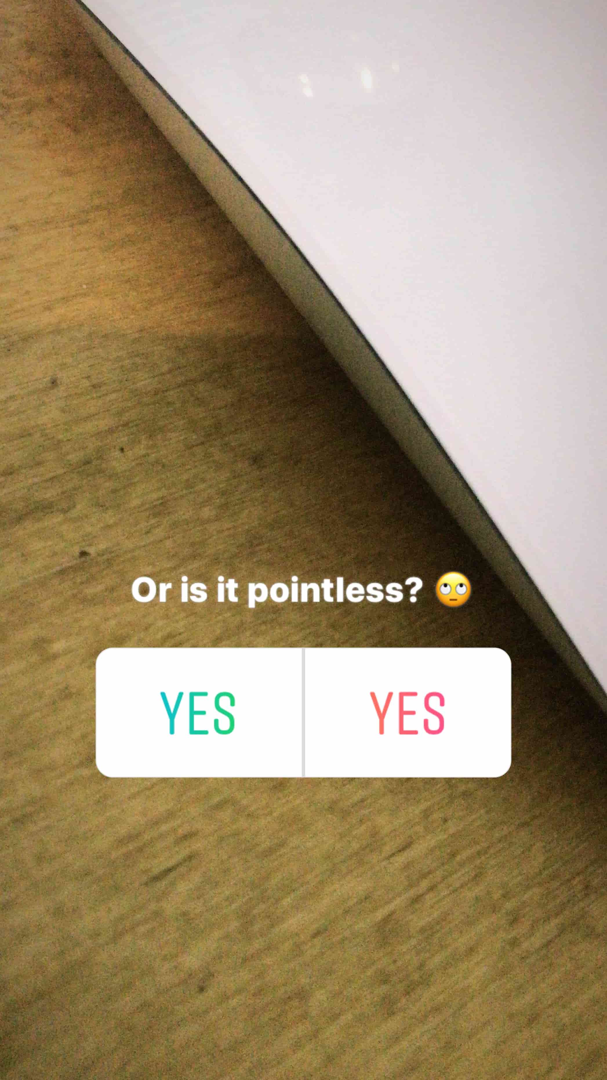 corner of white apple mouse on desk with poll and text saying or is it pointless with yes as both answer options