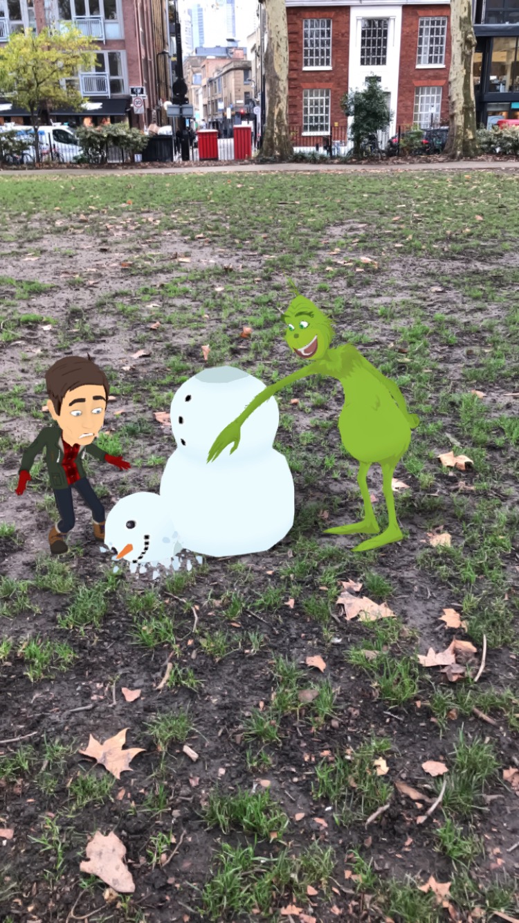 Cartoon version of the Grinch laughing as he pushes the head off a cartoon snowman which splats on the floor while the brown-haired white male author's Bitmoji watches with a terrified expression on his face